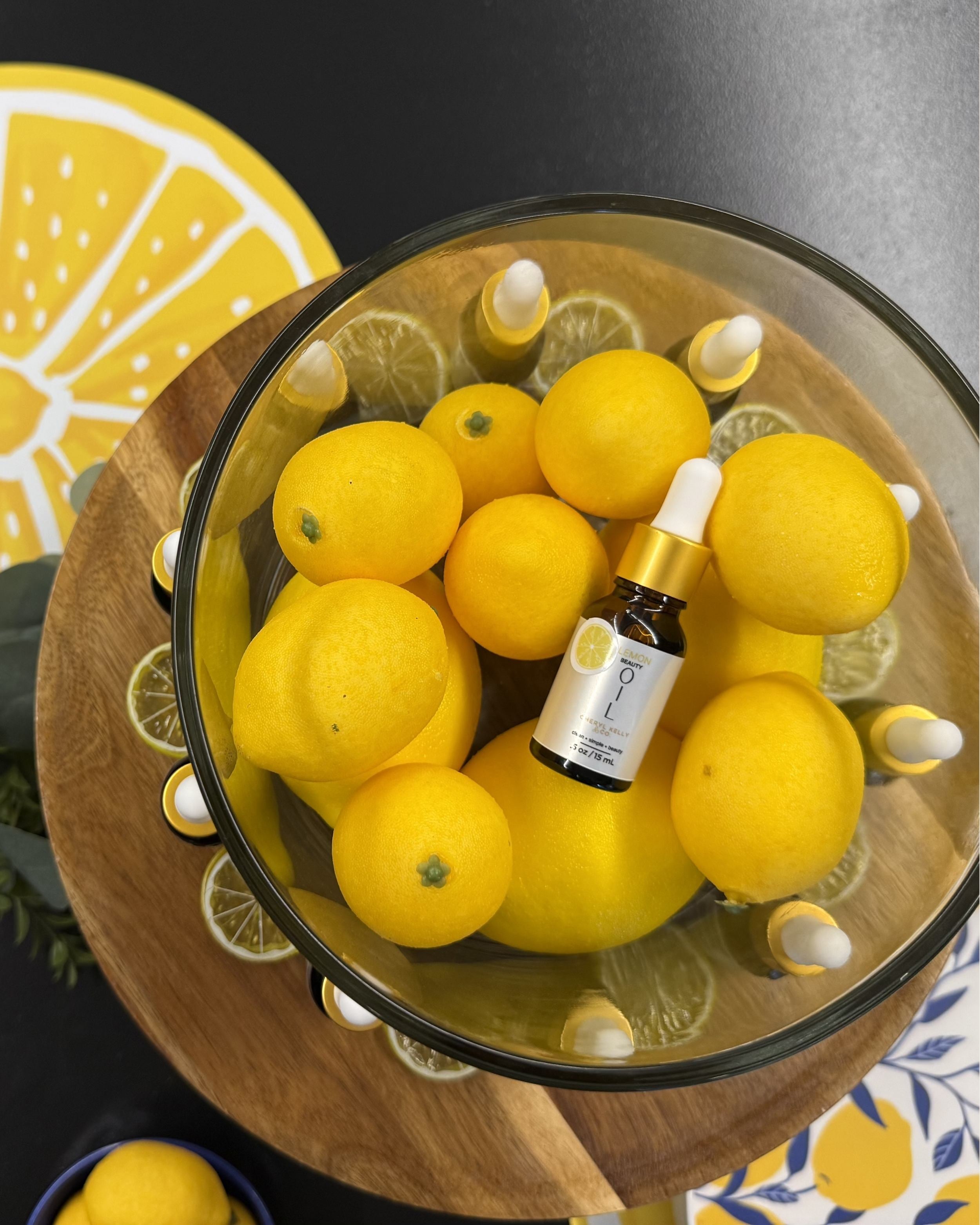 Lemon Beauty Oil Summer Edition surrounded by fresh lemons.