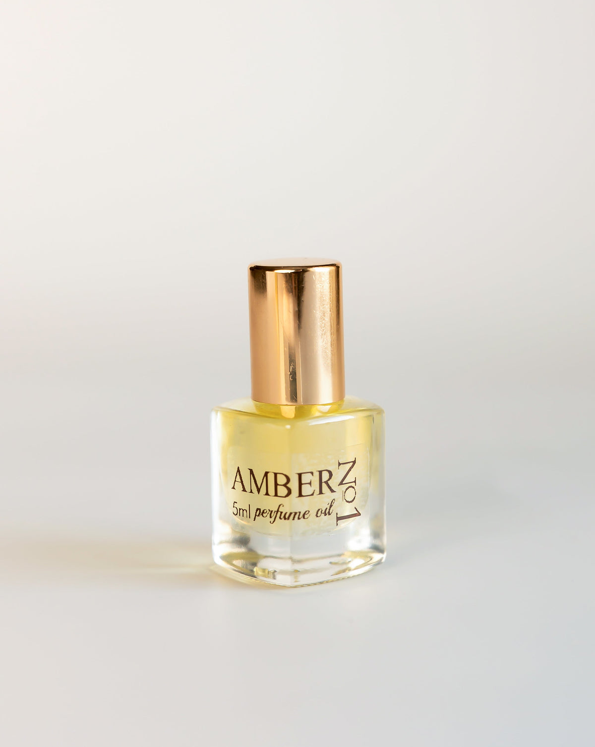5 mL Amber No1 perfume oil in a clear glass bottle with a gold cap on a white background