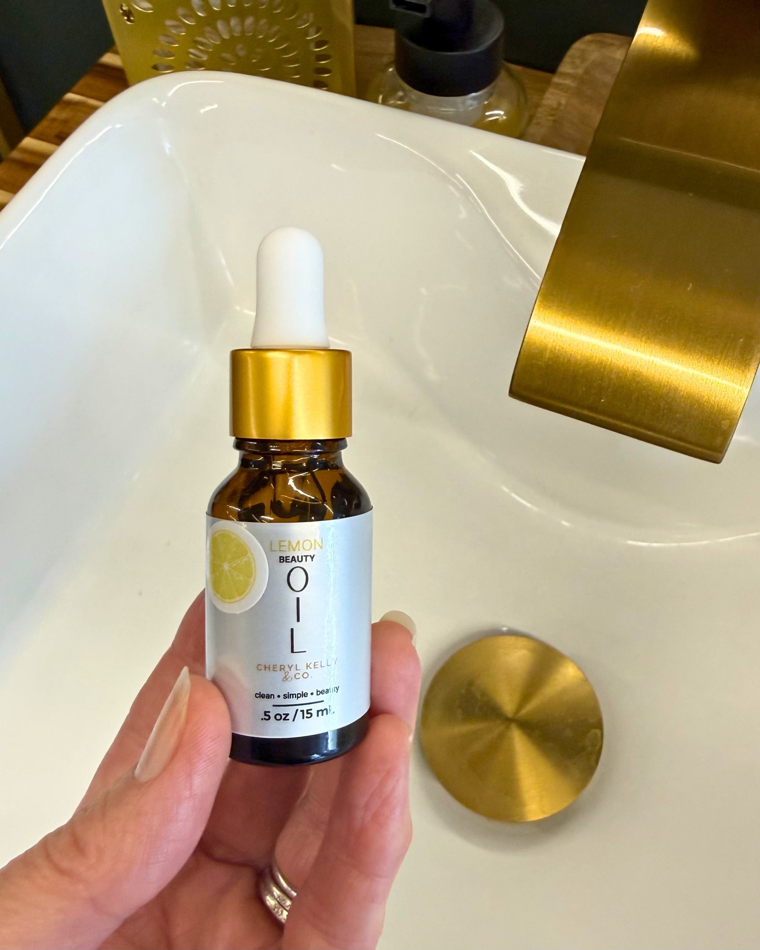 Lemon Beauty Oil Summer Edition bottle shown in hand for size reference.