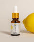 Cheryl Kelly & Co. Lemon Beauty Oil Summer Edition clean facial oil next to fresh lemon on white background